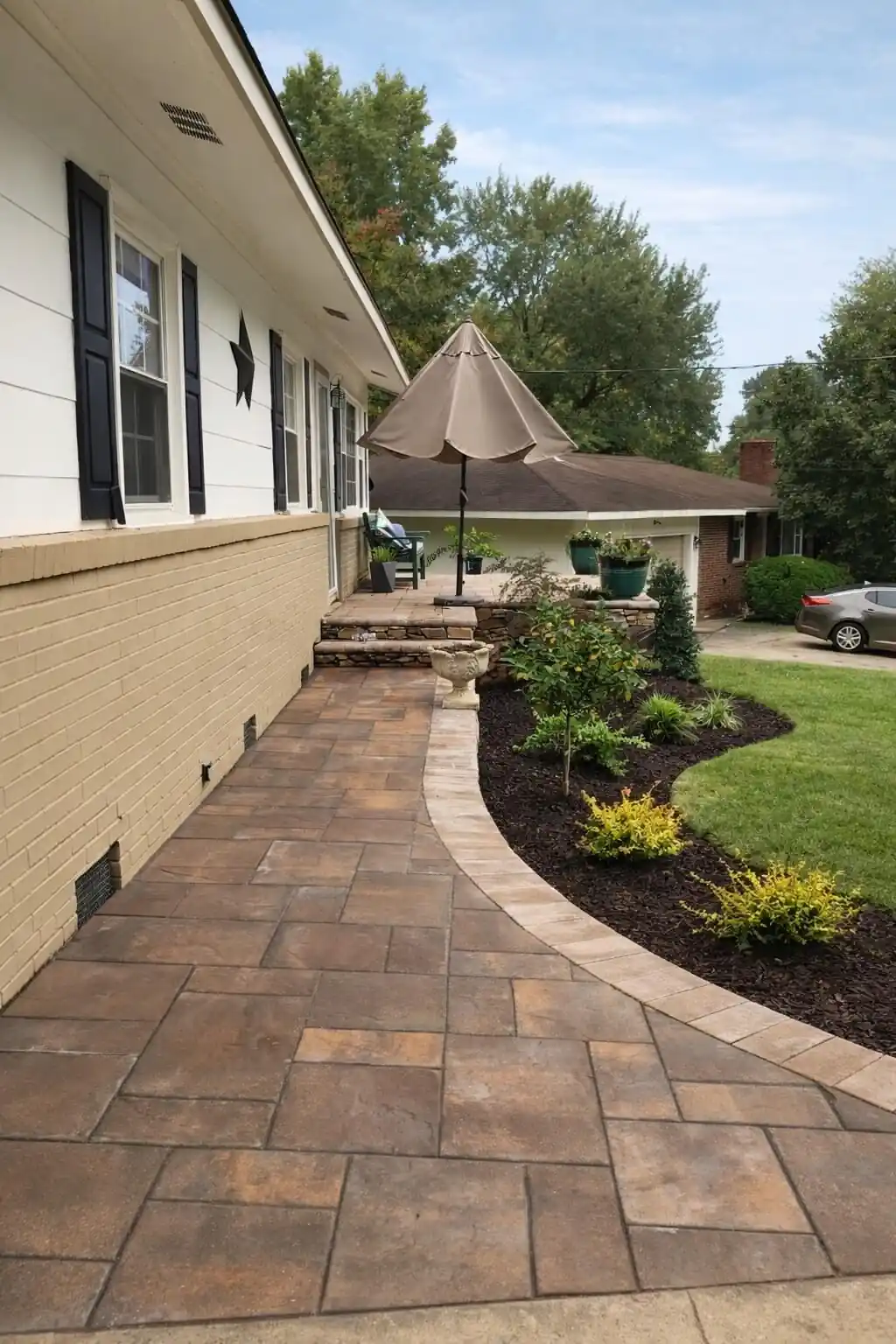 Raised paver patio with stone retaining wall Greensboro NC